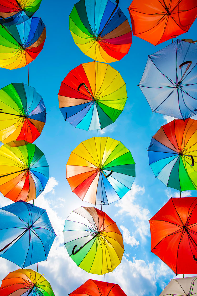 colorful umbrellas with a sky backbround